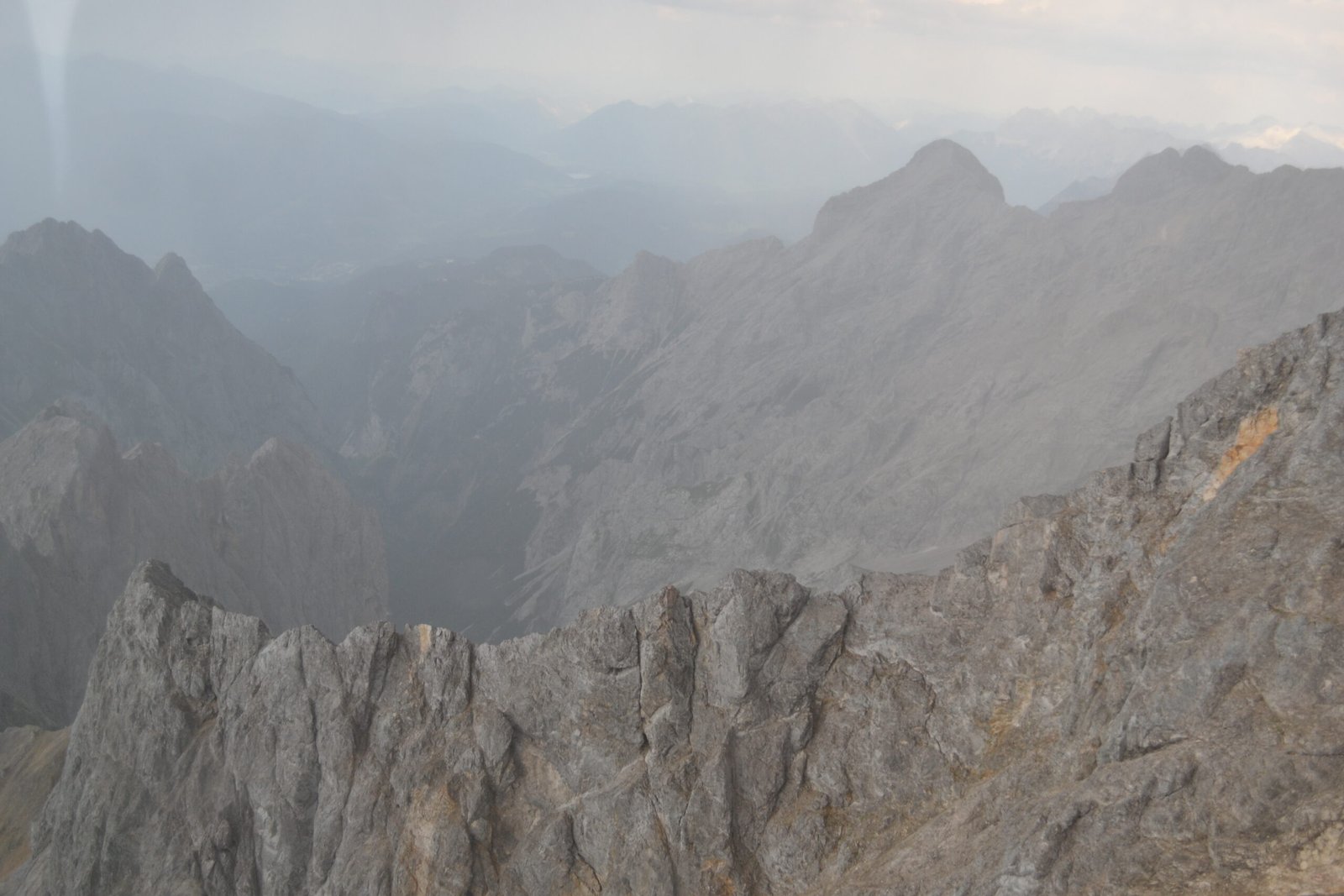 Layers of rocky mountain ridges disappearing into mist